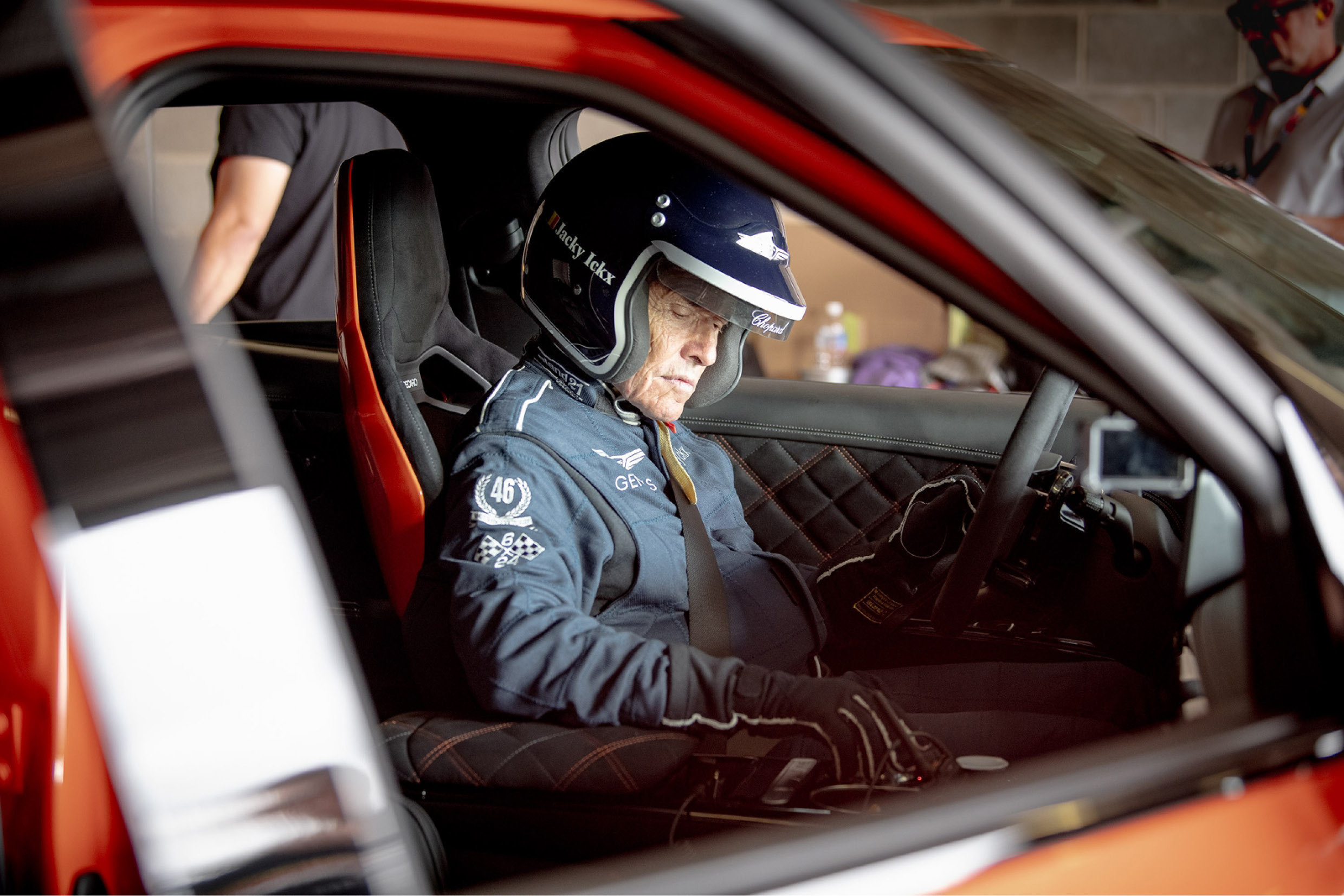 Jacky Ickx sitting in the driver's seat