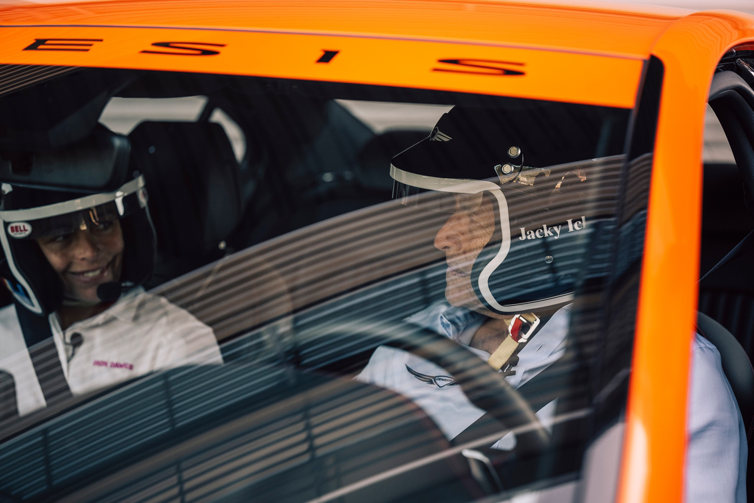 A racing driver sitting in the driver's seat
