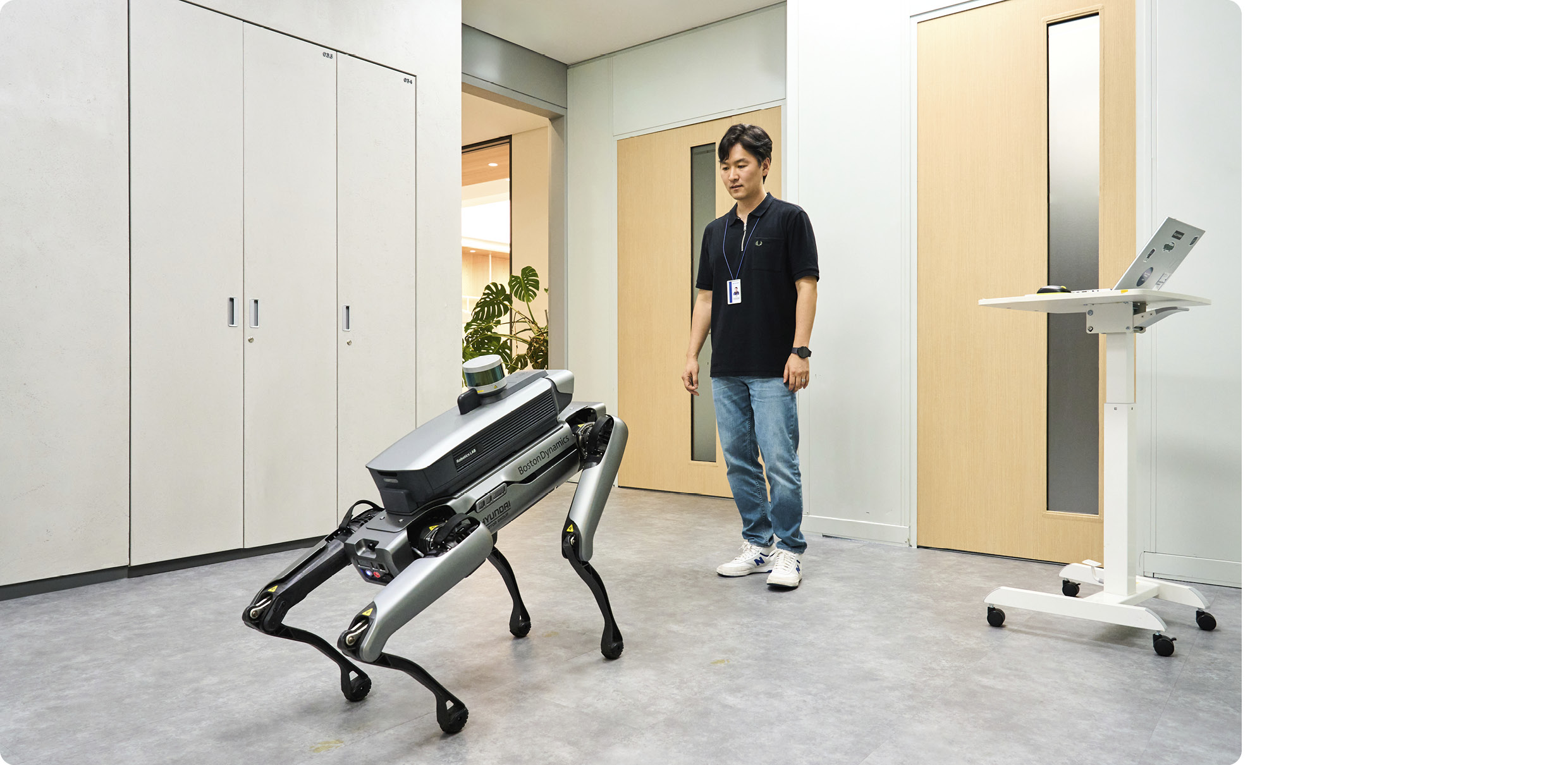 Researcher Demonstrating Face Recognition Function of Four-legged Robot Spot
