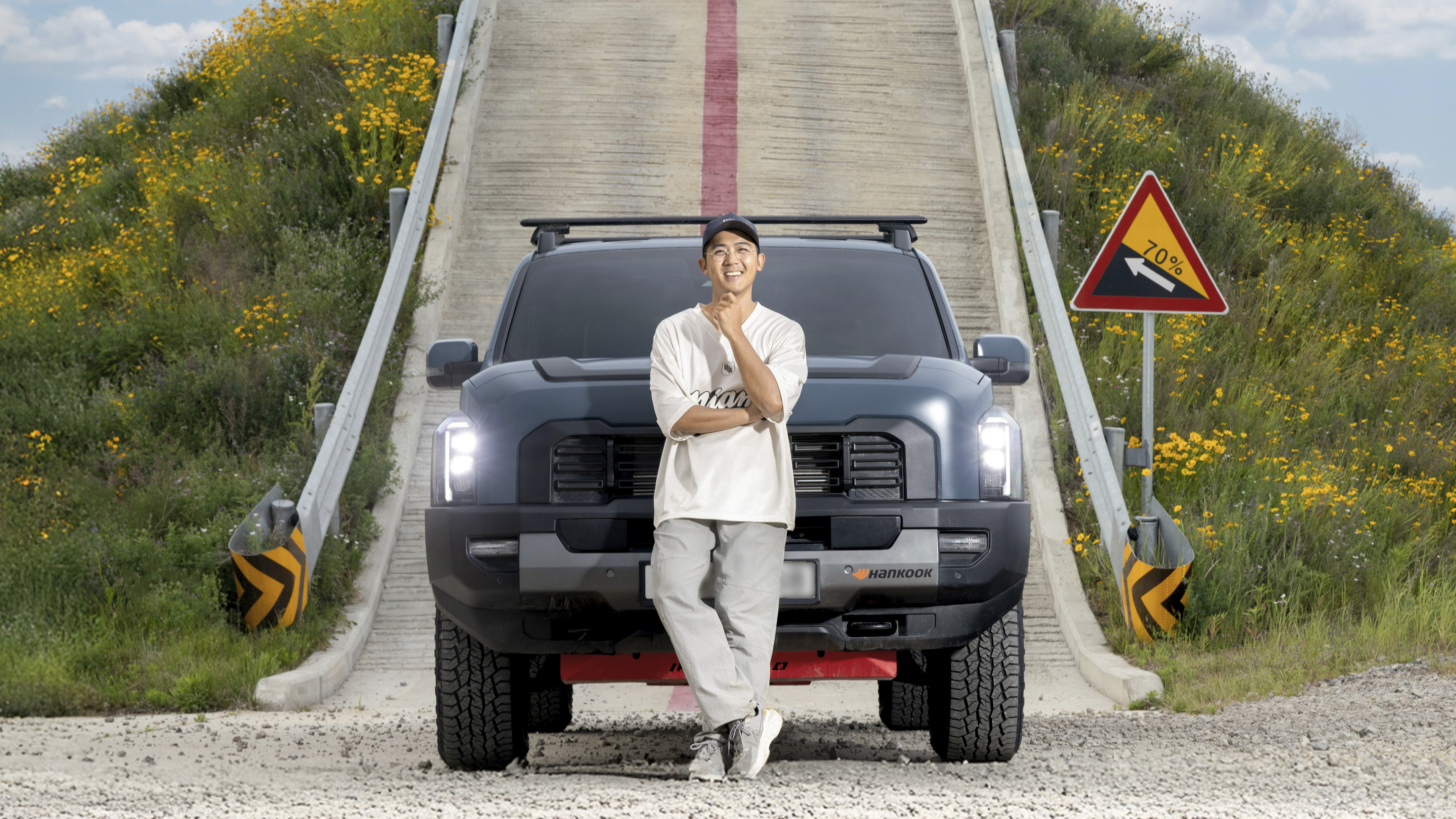 자동차 인플루언서가 타스만 앞에 서 있는 모습