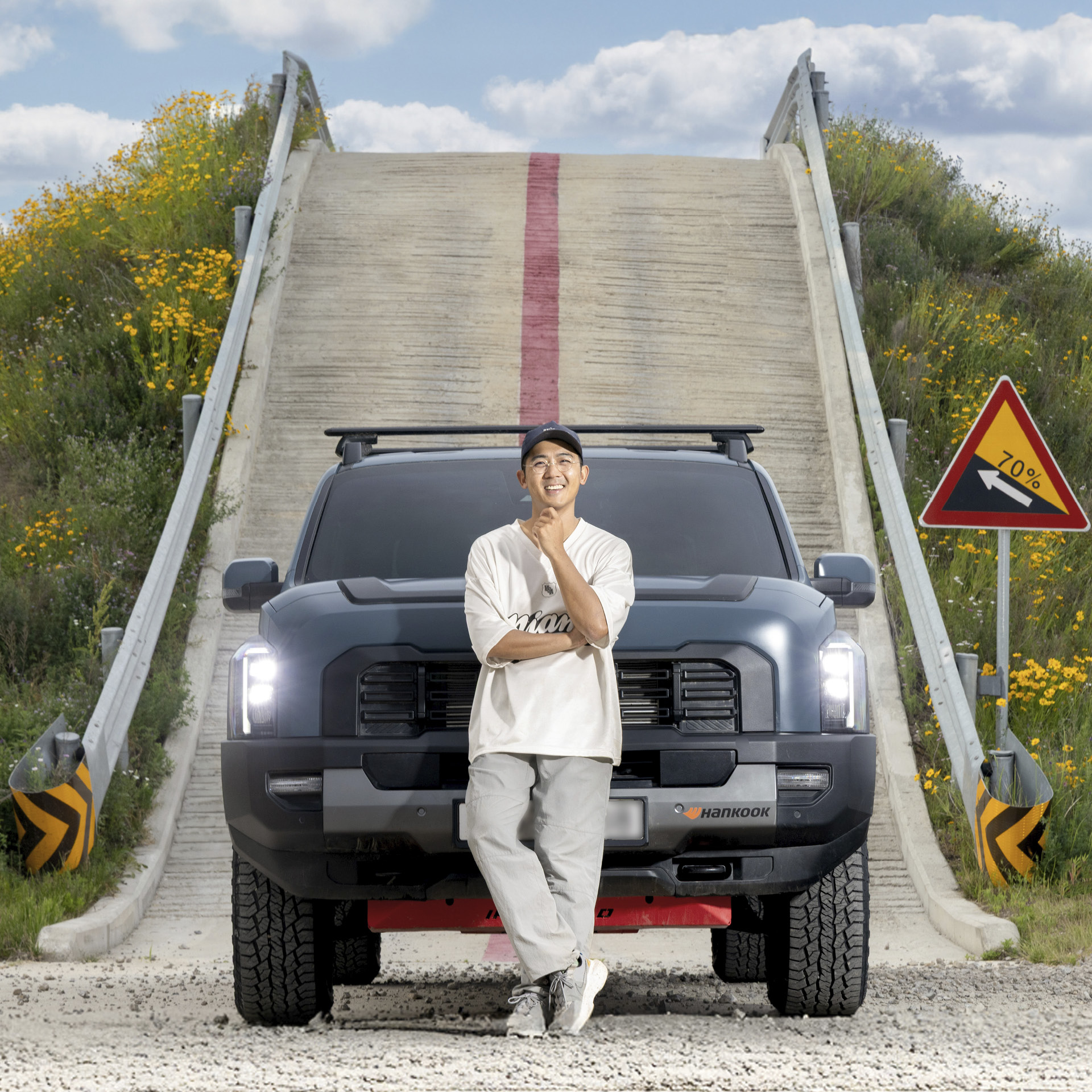 The car influencer is standing with the Tasman