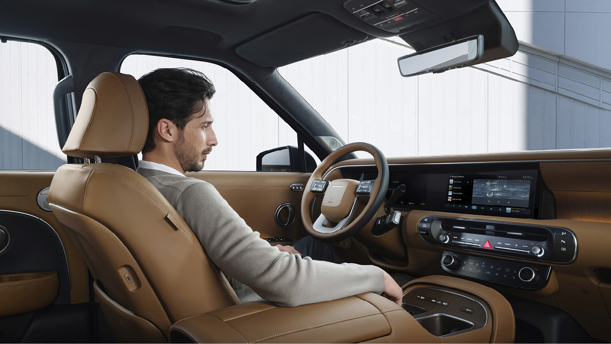 팰리세이드 하이브리드의 실내에 성인 남성이 앉아있는 모습