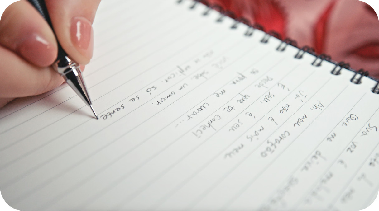 writing down the lyrics on notebook