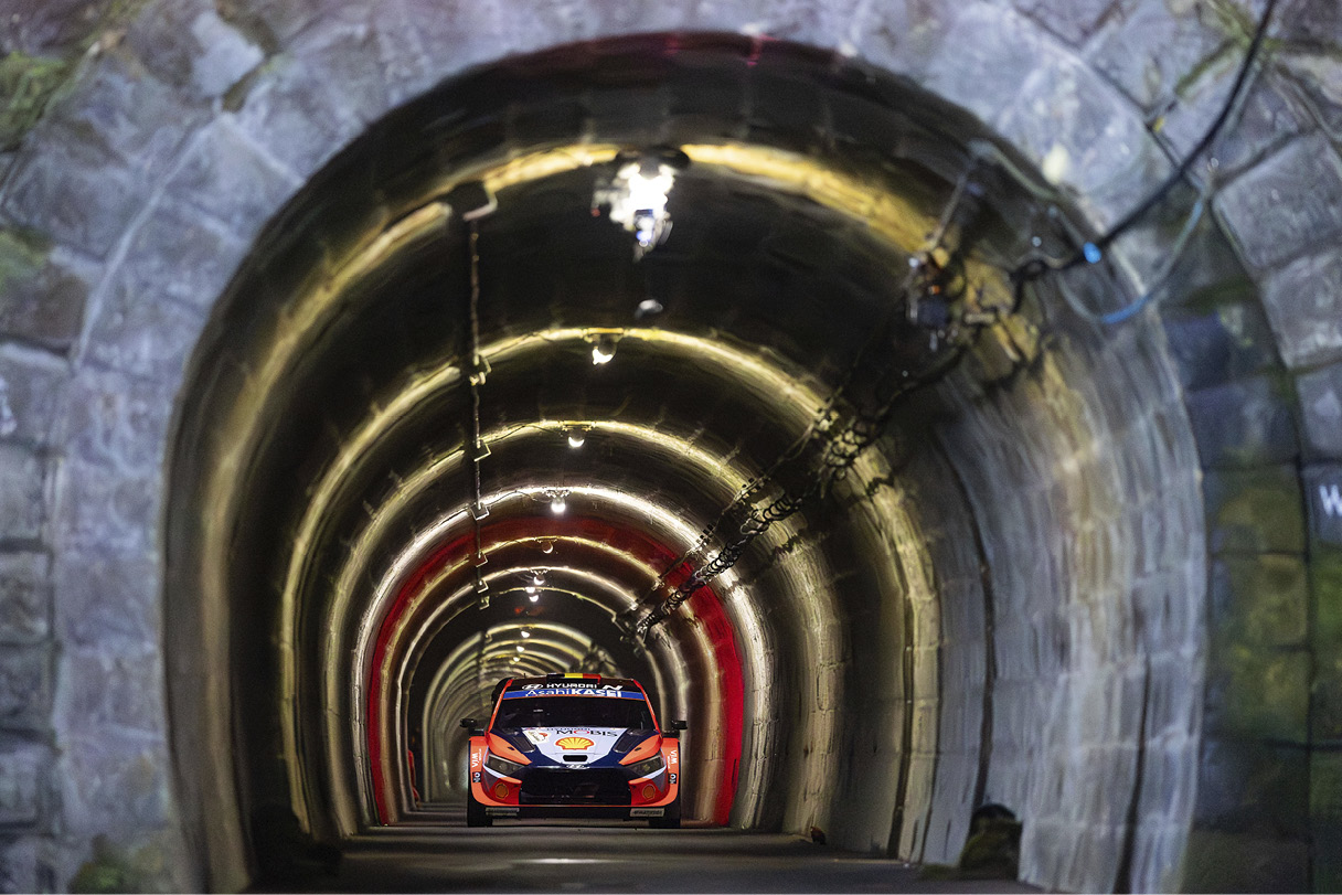 Front view of Hyundai team rally car driving through tunnel