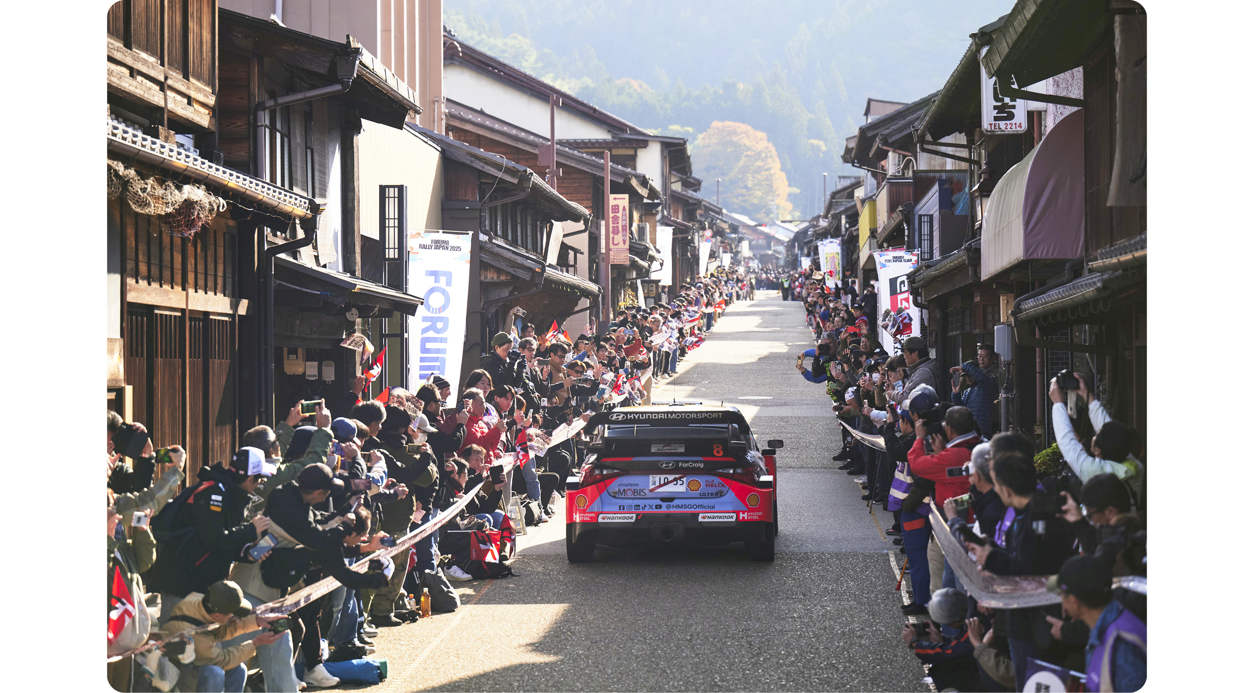 Hyundai Team Rally Car Driving Between Japanese Rally Spectators