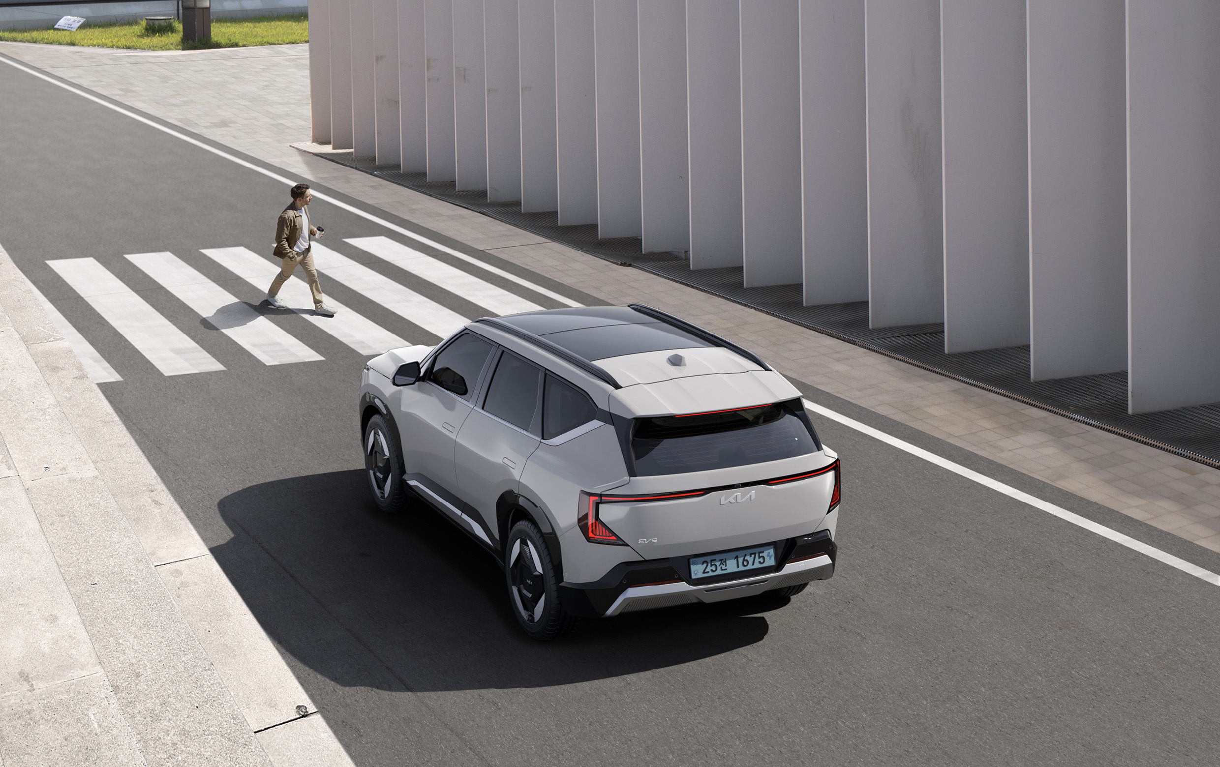 A Kia EV5 Standing In Front Of A Pedestrian