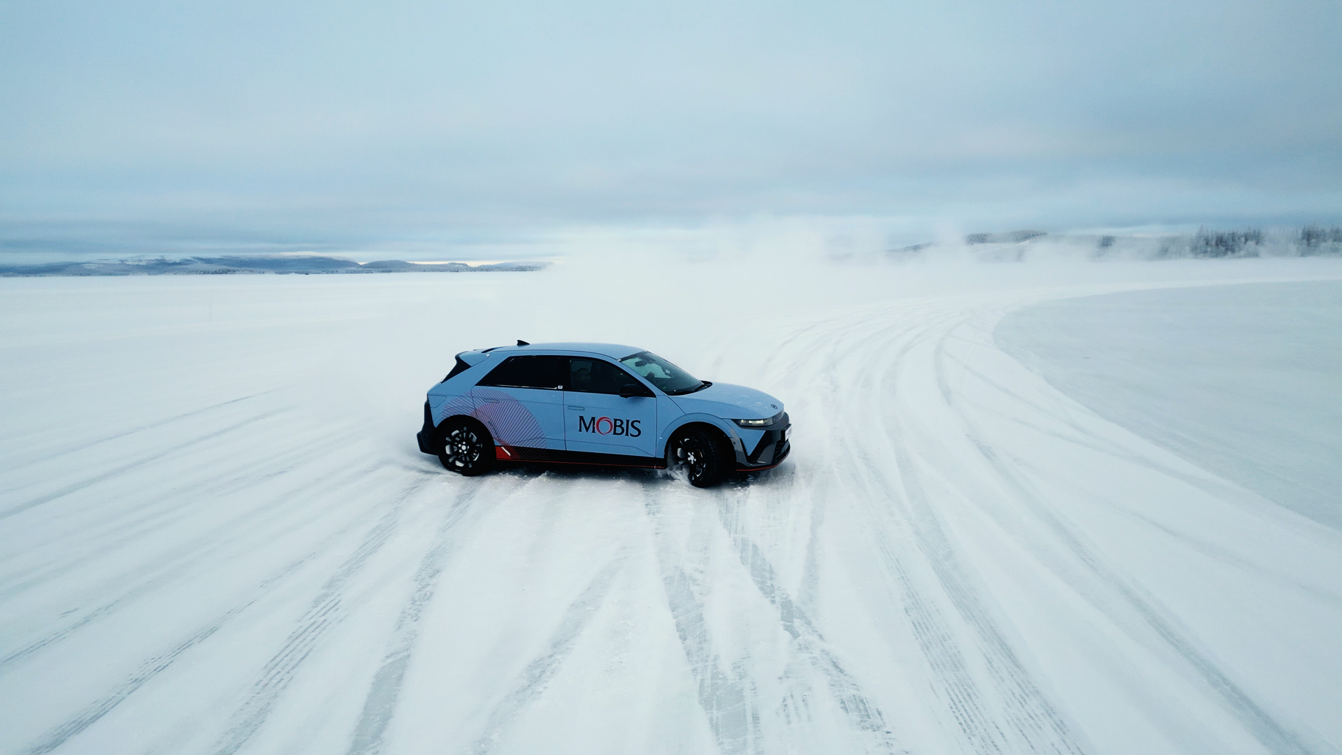 A test vehicle driving across the snow-covered Swedish winter testing ground