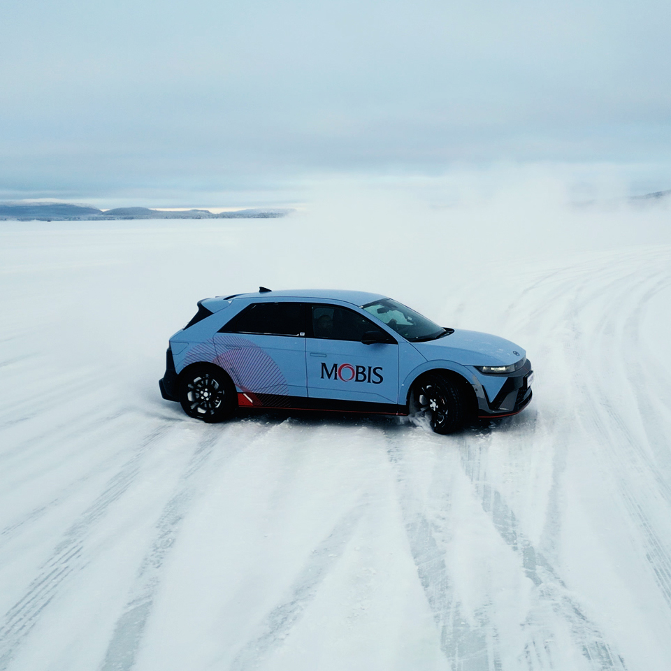 A test vehicle driving across the snow-covered Swedish winter testing ground