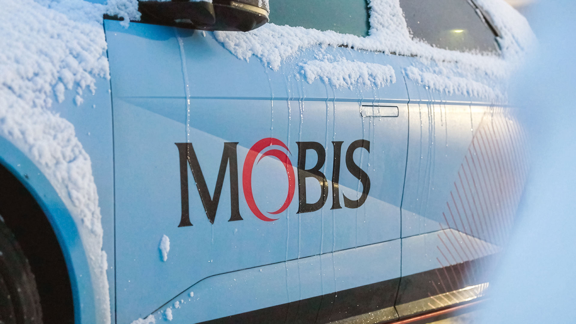 Close-up image of the ‘MOBIS’ logo attached to the vehicle exterior