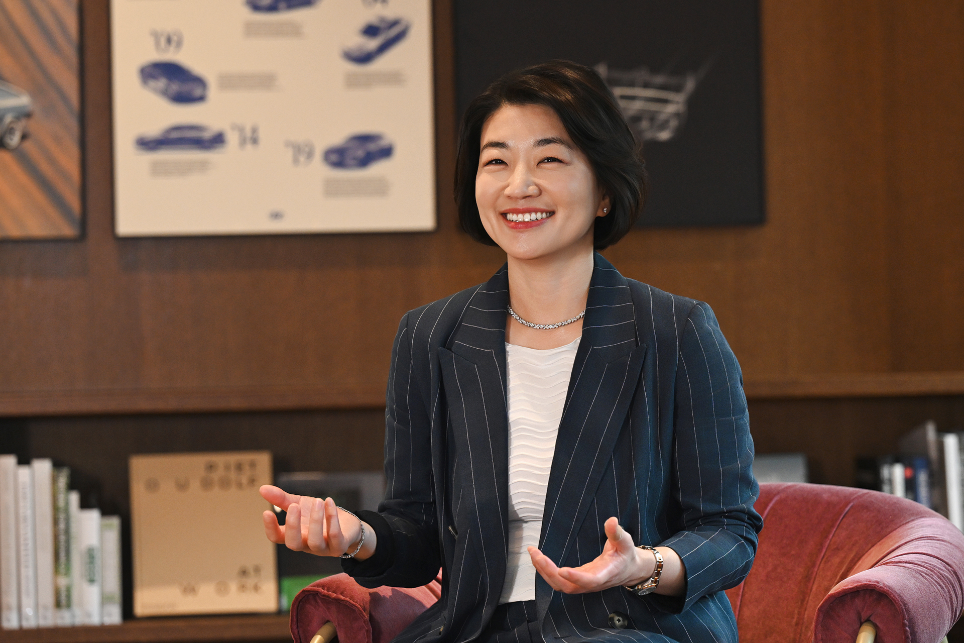 HMG CHRO Hae In Kim conducting an interview while seated on a sofa