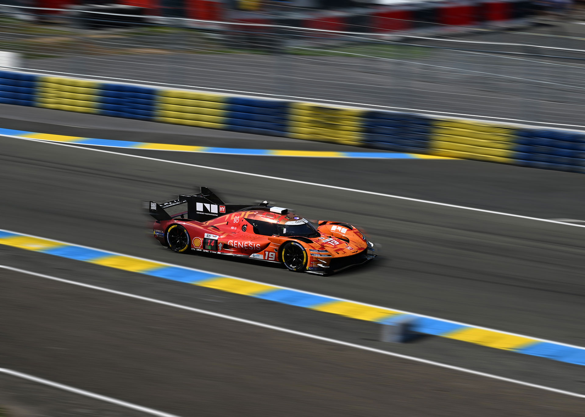 The GMR-001 #19 car speeding around the circuit.
