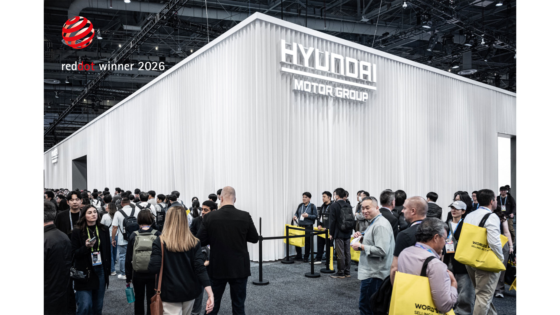 Crowded Hyundai Motor Group booth with white pleated exterior and 3D signage at CES 2026